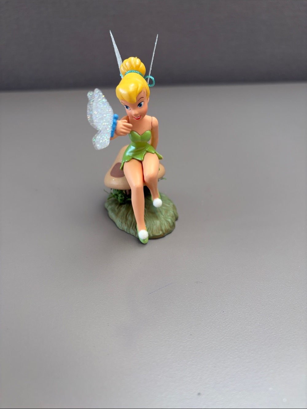 Hallmark Tinker Bell ornament sitting on a mushroom with a butterfly with box